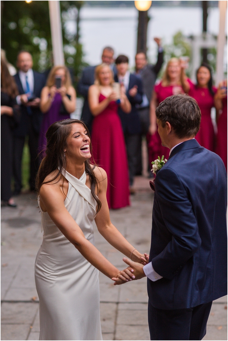 Allie & Cam's autumn riverside Richmond wedding at Celebrations at the Reservoir with a first dance under the lights, forest newlywed portraits, a dessert table, and a signature drink named after their dog.