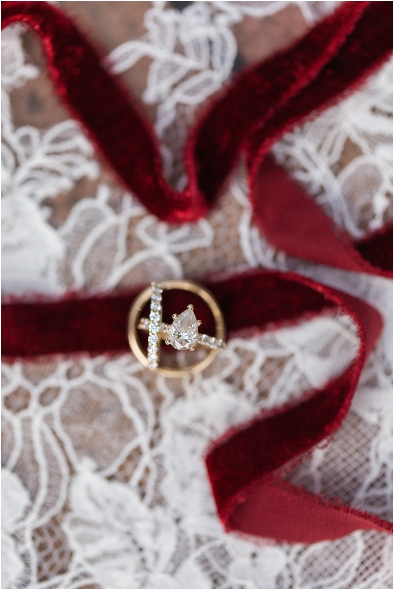 Rachael & Trent's red velvet and white winter wedding at the Inn at Willow Grove with a first look with bridesmaids, first look and letter reading, ceremony in the hidden garden, sunset mountain newlywed portraits, and a fairy light tent reception. Close up detail photo of wedding rings