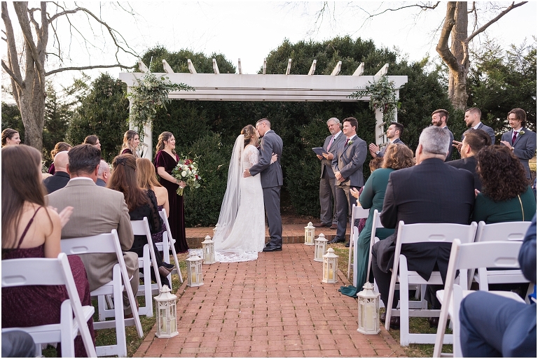 Rachael & Trent's red velvet and white winter wedding at the Inn at Willow Grove with a first look with bridesmaids, first look and letter reading, ceremony in the hidden garden, sunset mountain newlywed portraits, and a fairy light tent reception.
