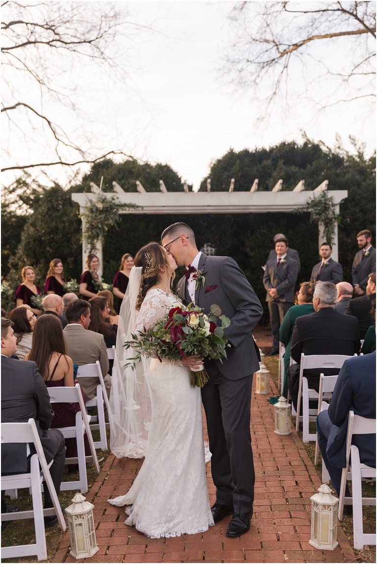 Rachael & Trent's red velvet and white winter wedding at the Inn at Willow Grove with a first look with bridesmaids, first look and letter reading, ceremony in the hidden garden, sunset mountain newlywed portraits, and a fairy light tent reception.