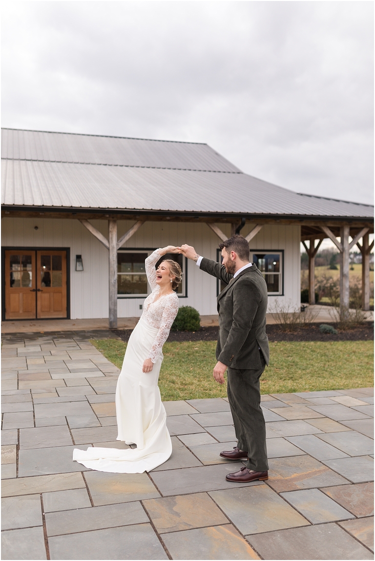 Kristin & Casey's green corduroy winter white barn wedding at Renback Barn with a custom wedding name sign, mountain view wedding portraits, all black wedding party clothes, wedding jean jacket, and sparkler exit.