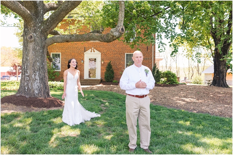 Family farm and barn spring wedding first look with bride's father