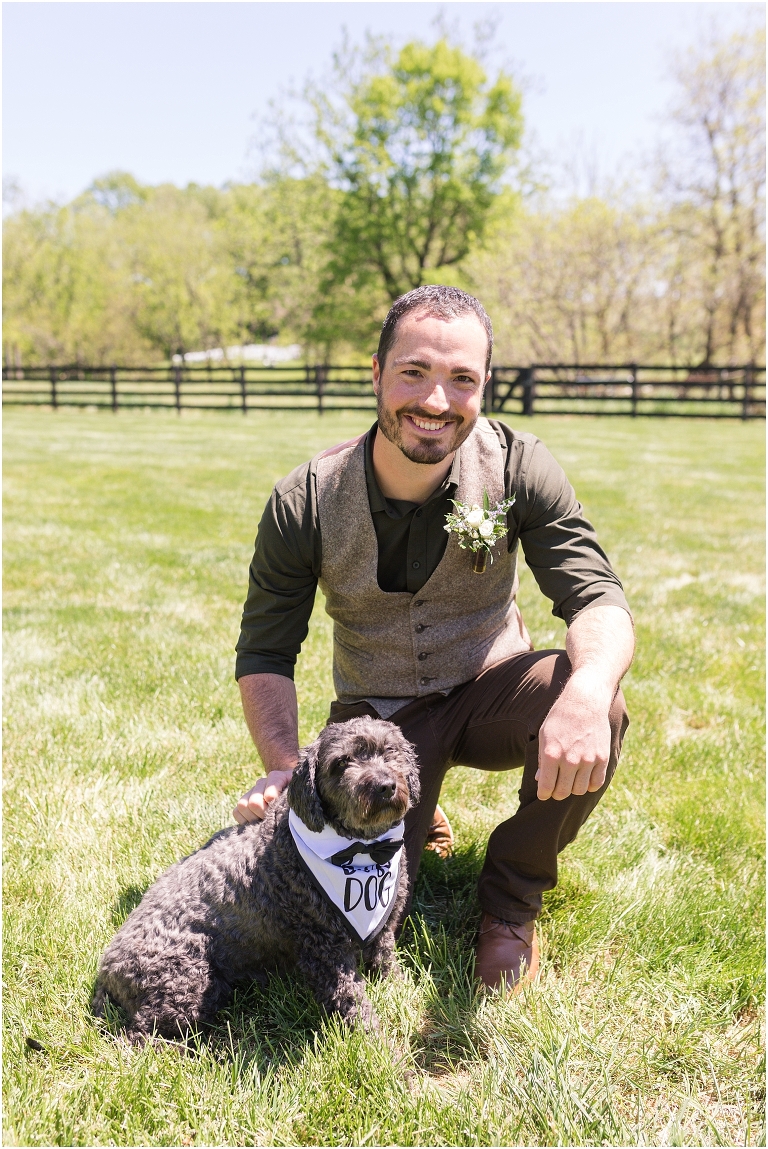 Family farm and barn spring wedding groom portraits with his dog