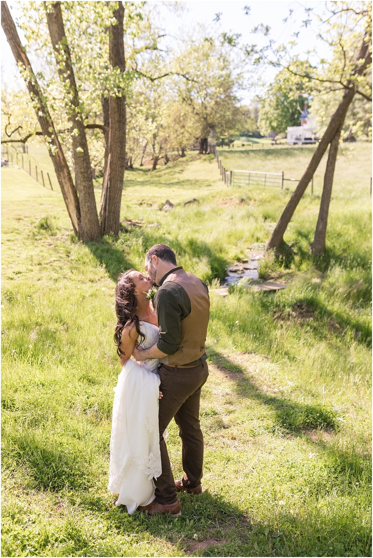 Family farm and barn spring wedding newlywed portraits in a creek