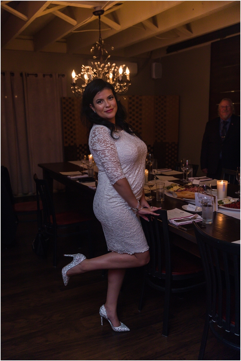 The bride showing off her sparkly heels and reception dress at the restaurant after her mountain elopement