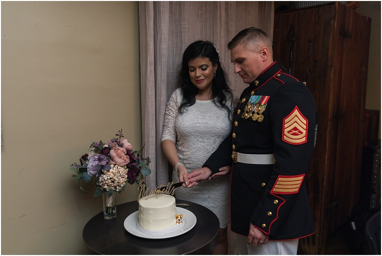 A newlywed couple cutting the cake at their restaurant reception
